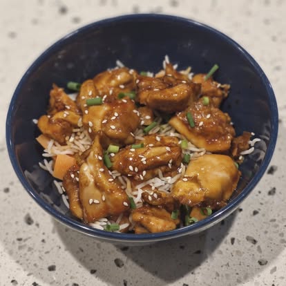 Sticky sesame chicken served with rice